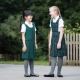 Junior school pinafores plain and tartan designs in school uniform colours